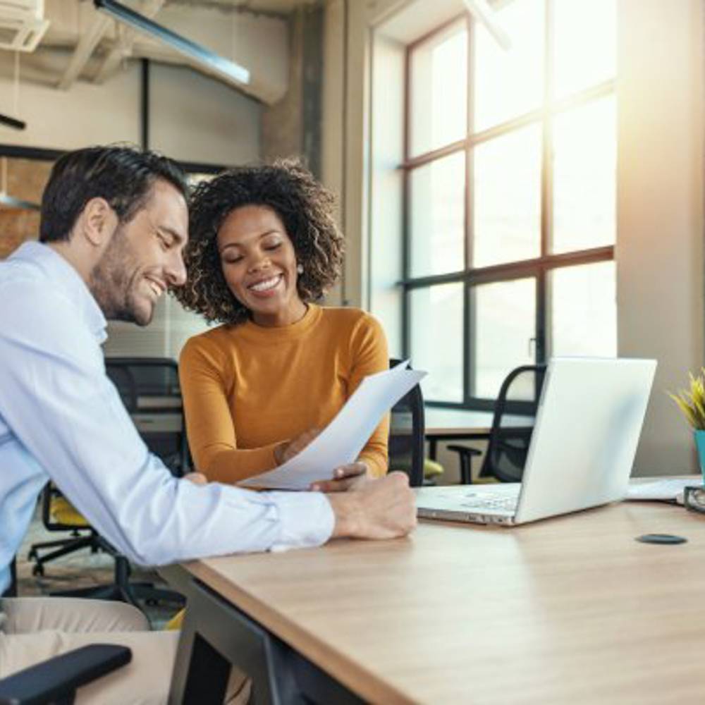 Two Business People Looking At Paper