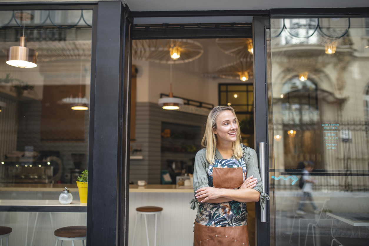Woman Standing In Shop Doorway