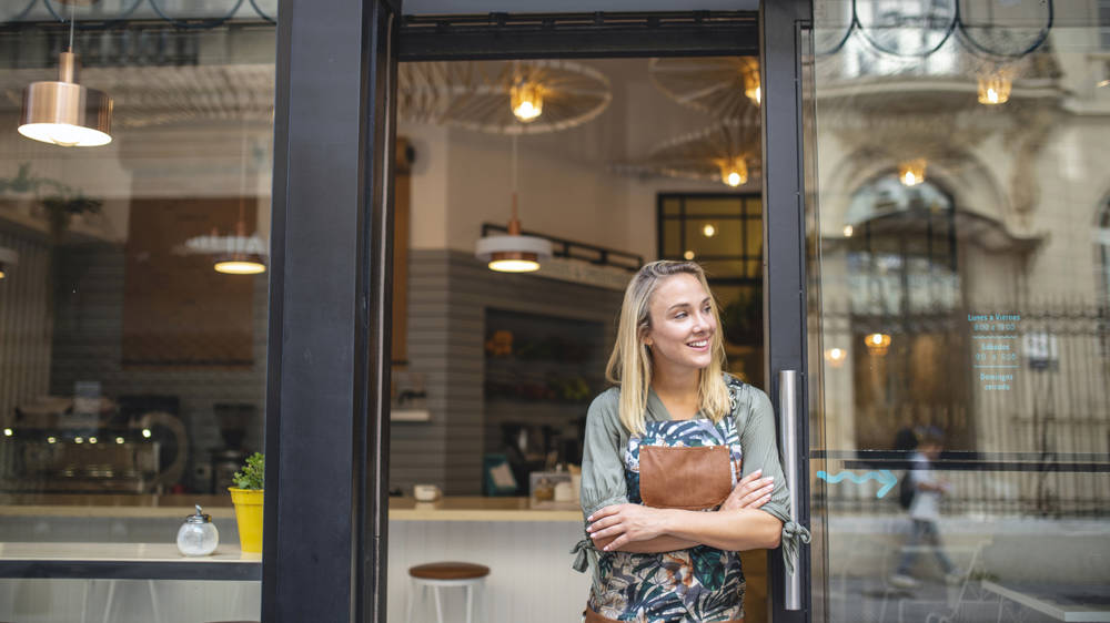 Woman Standing In Shop Doorway